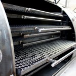 stainless steel cooking grills inside a custom built bbq smoker