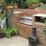 custom stainless steel built in bbq in a brick built garden kitchen